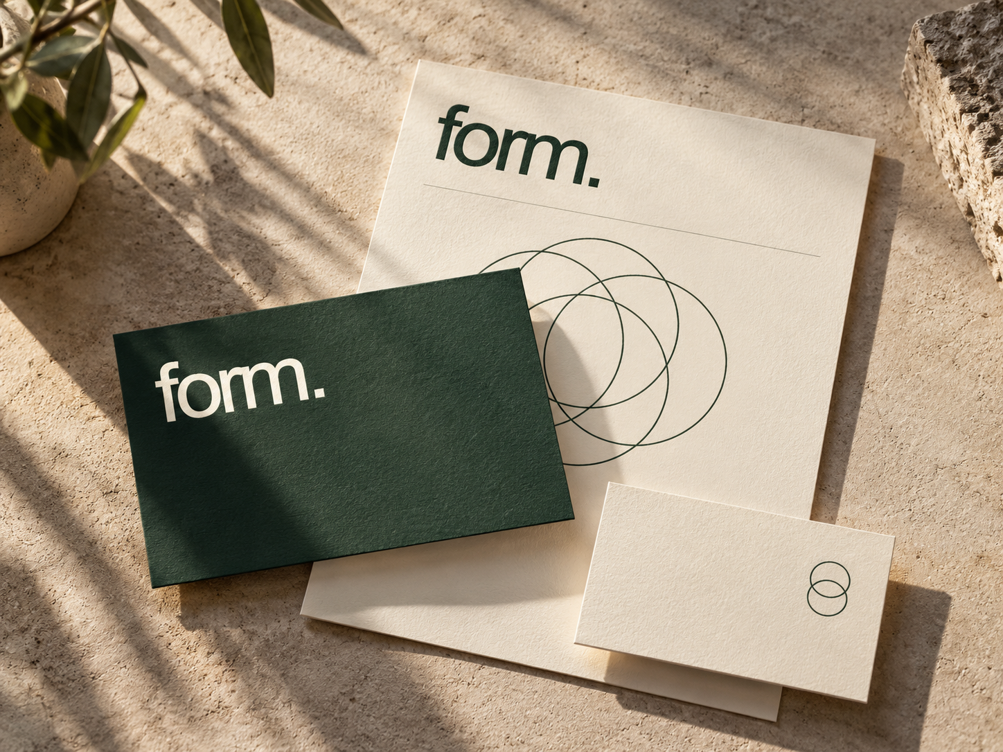 FORM concept identity: forest-green typography across cream stationery